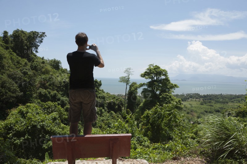 Caucasian man taking photograph of remote area