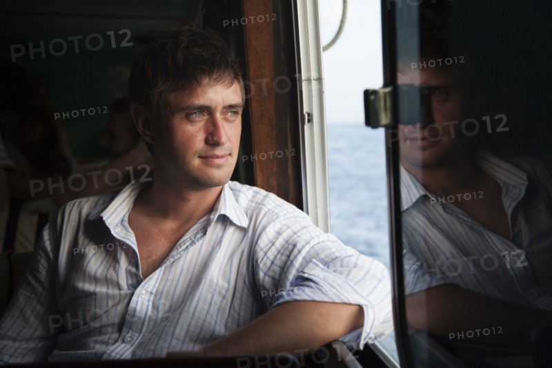 Caucasian man riding in boat