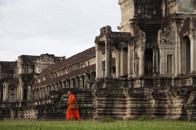 Priest walking near Angkor Wat temple