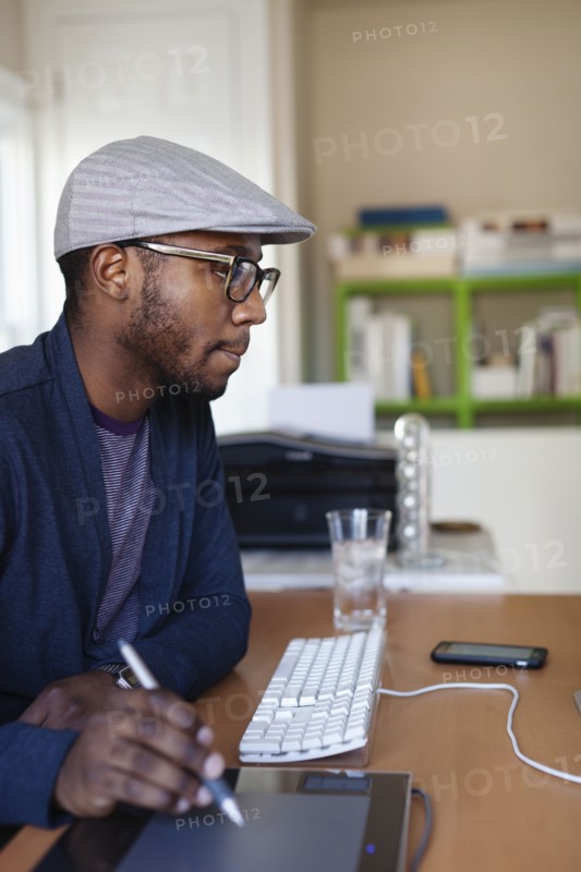 Black designer working at desk