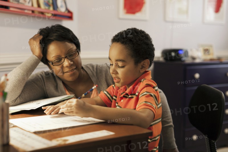 Mother helping son with homework