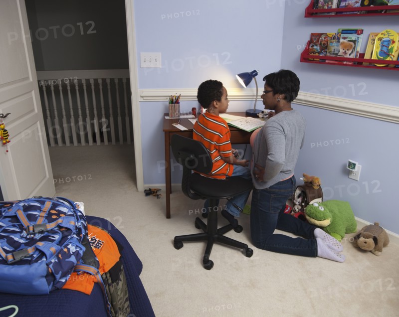Mother helping son with homework