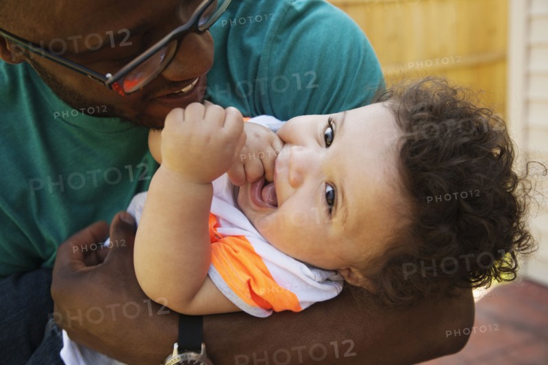 Father and baby playing outdoors
