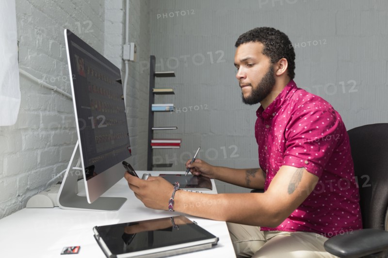 Mixed race businessman working at desk