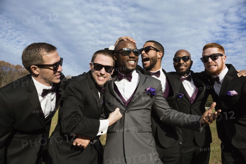 Groom and groomsmen posing for wedding pictures