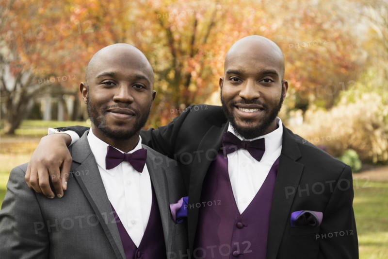 Black groom and best man posing at wedding