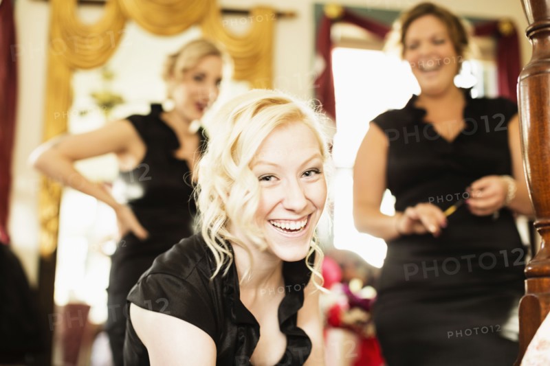 Caucasian bridesmaids smiling together