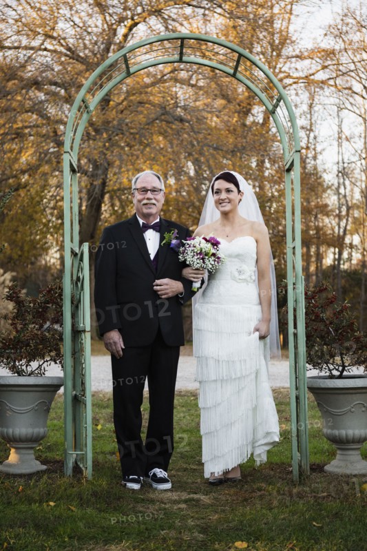 Caucasian father walking bride down aisle