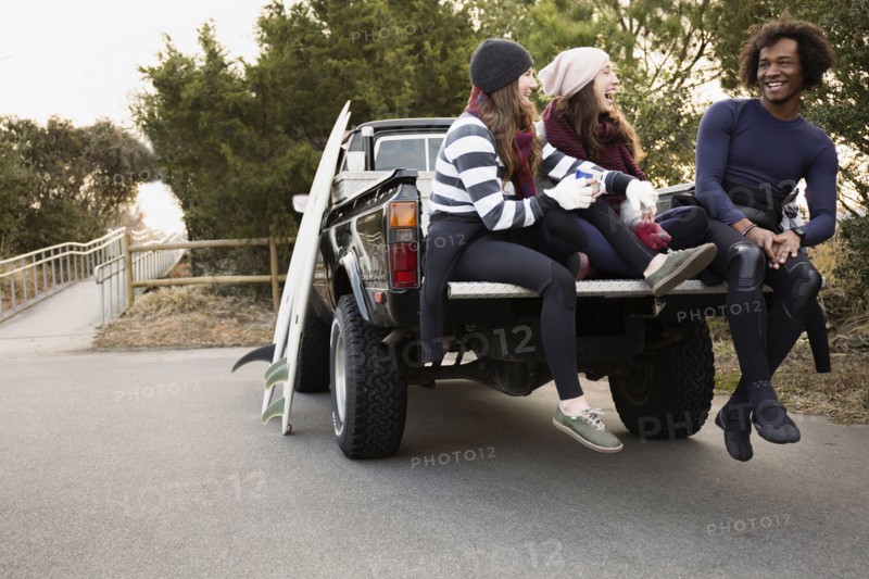 Friends having coffee together in truck bed