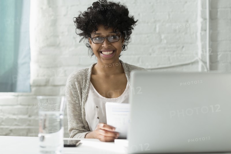 Mixed race architect working at desk