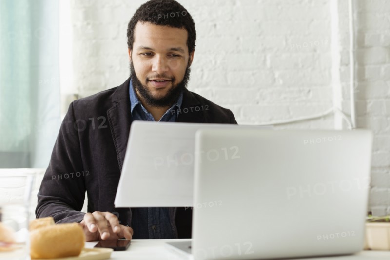 Mixed race businessman working at desk