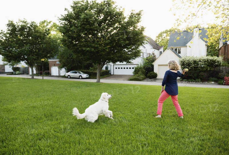 Caucasian woman playing with dog in park