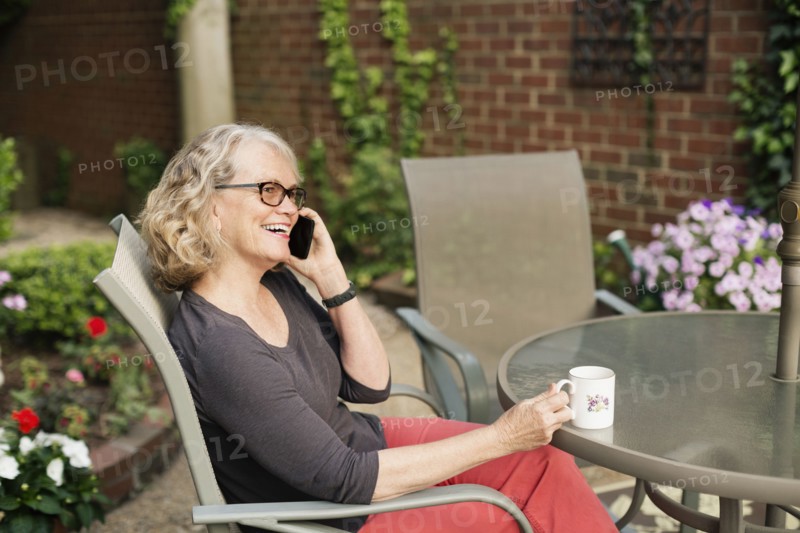 Caucasian woman talking on cell phone outdoors