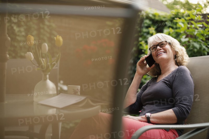 Caucasian woman talking on cell phone outdoors