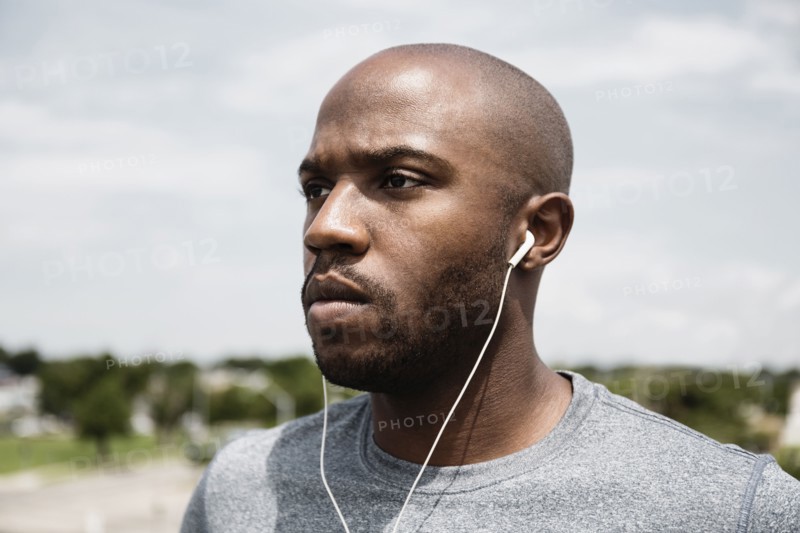 Black runner listening to earbuds