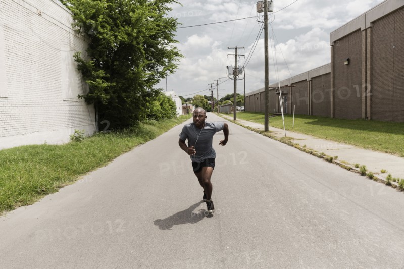 Black man running on city street