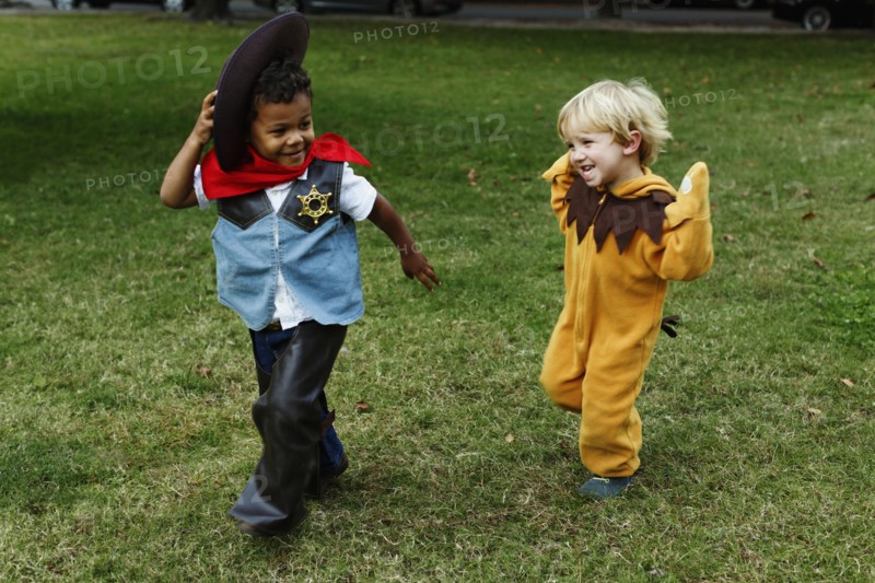Boys playing in costumes in park