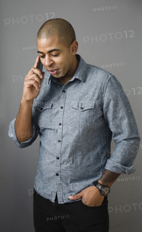Mixed race man talking on cell phone