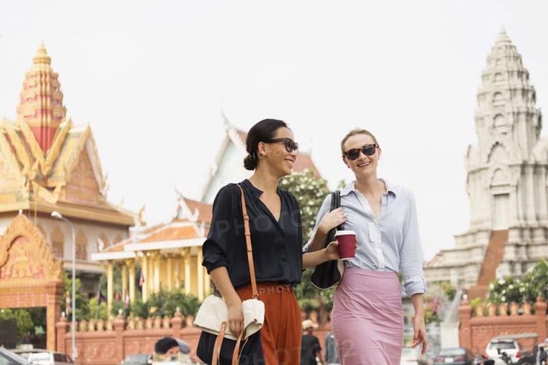 Businesswomen walking by ornate temple
