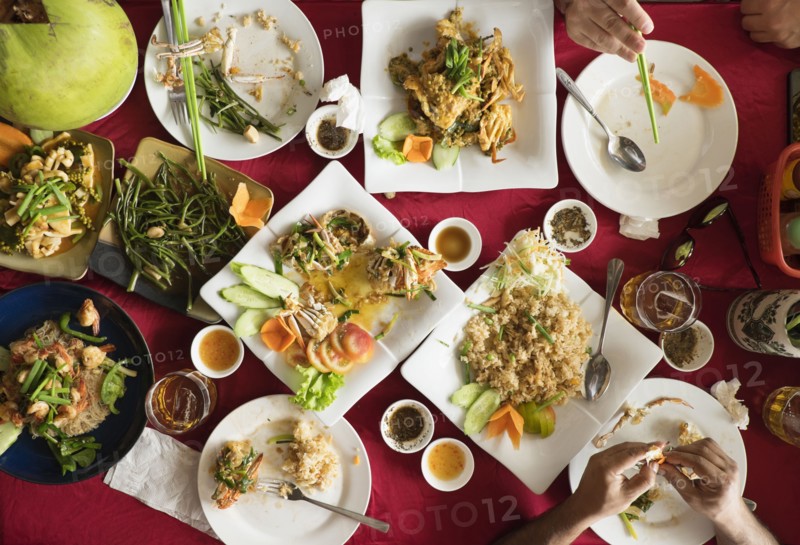 Overhead view of seafood and salad dishes on table