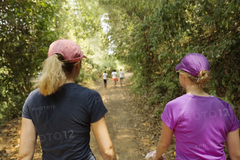 Women walking on remote dirt path