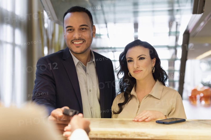 Business people checking into hotel with concierge