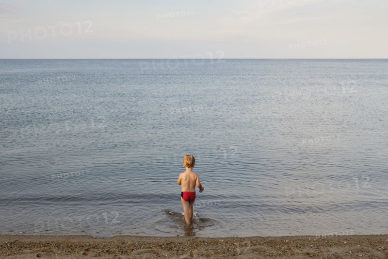 Caucasian boy playing on beach
