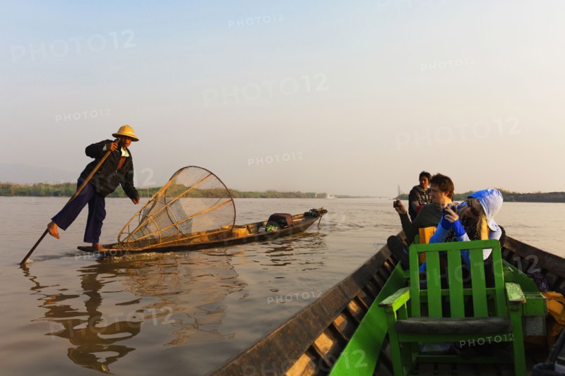 Tourists riding in canoe on rural lake