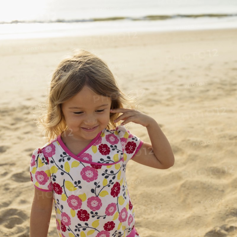 Mixed race girl smiling on beach
