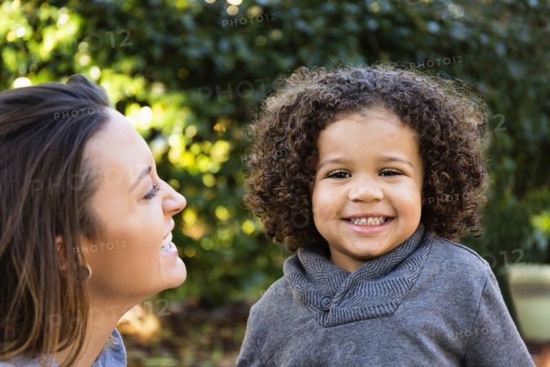 Mother and son smiling outdoors