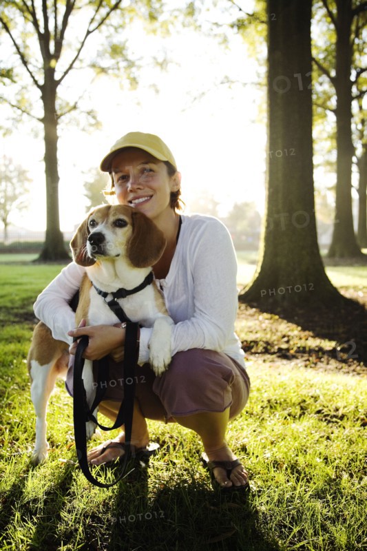 Caucasian woman hugging dog in park
