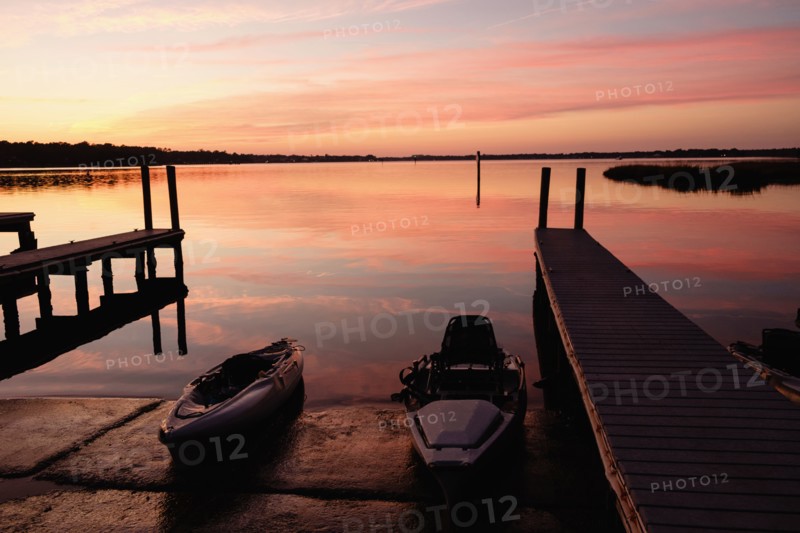 Kayaks near dock at sunset