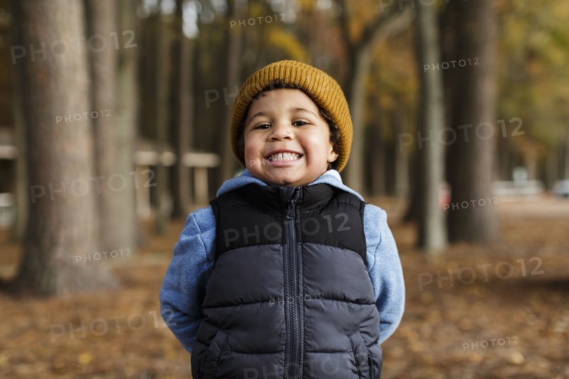 Portrait of smiling Mixed Race boy in park