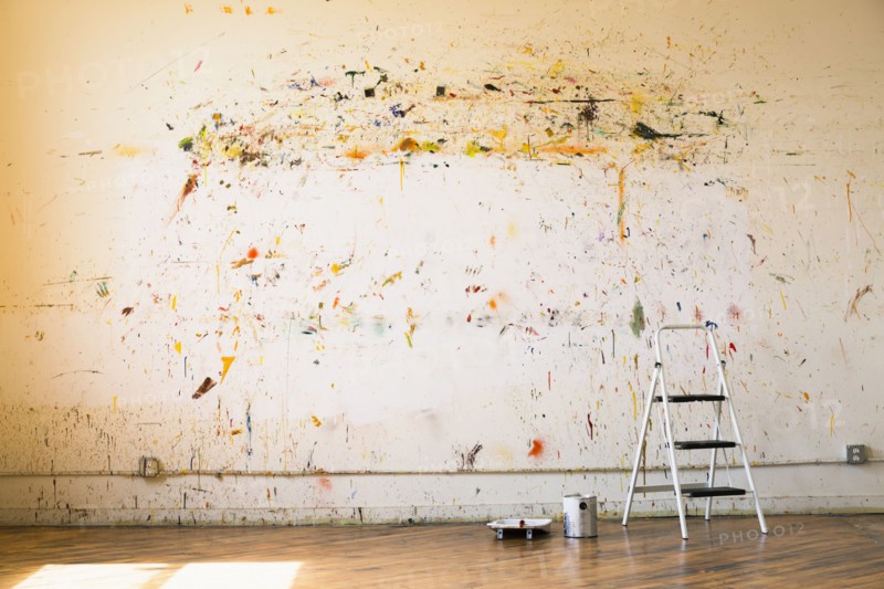 Paint splattered on wall near ladder