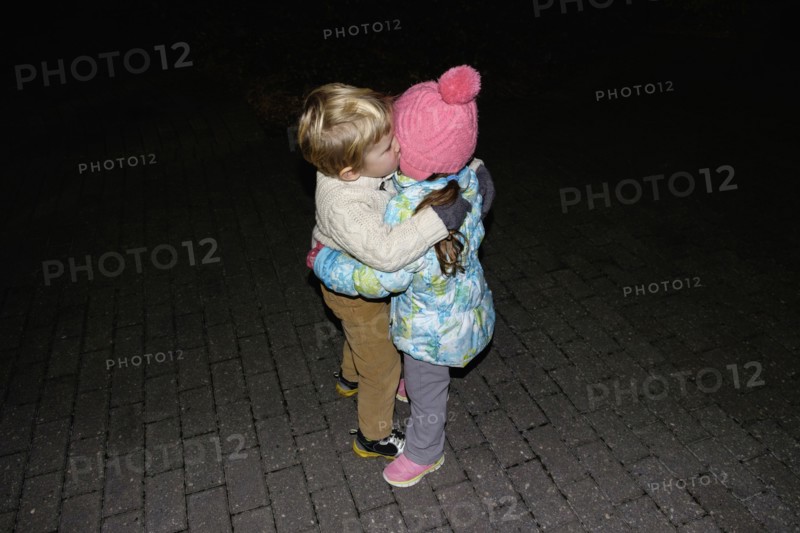 Boy ad girl hugging outdoors at night