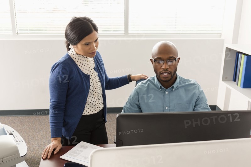Man and woman working at computer in office