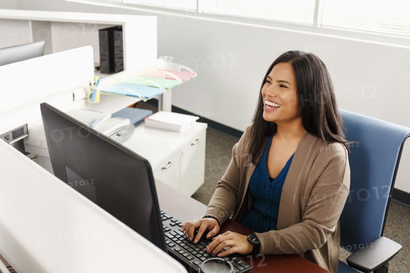 Pacific Islander woman using computer in office