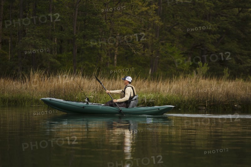 Caucasian man fishing on kayak