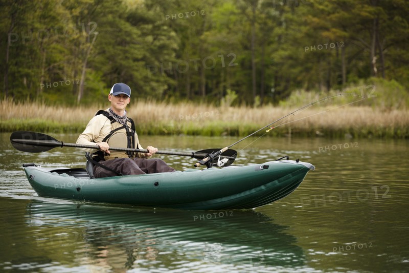 Caucasian man fishing on kayak