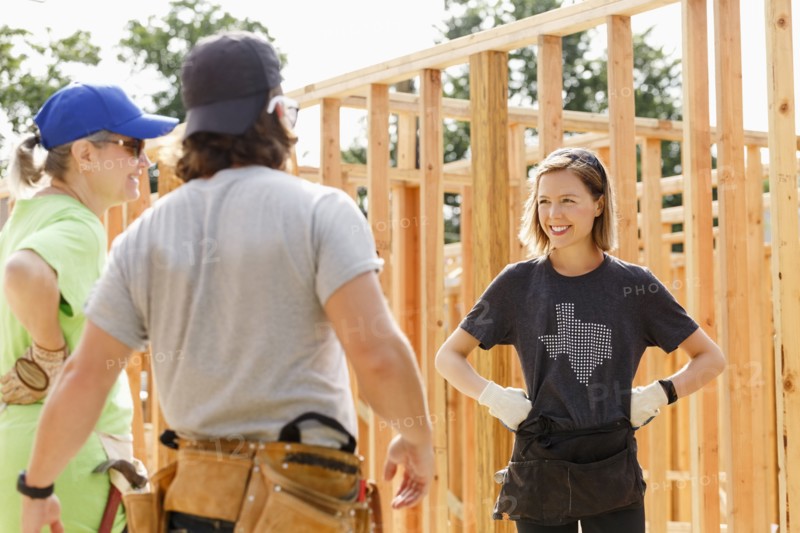 Caucasian volunteers standing at construction site
