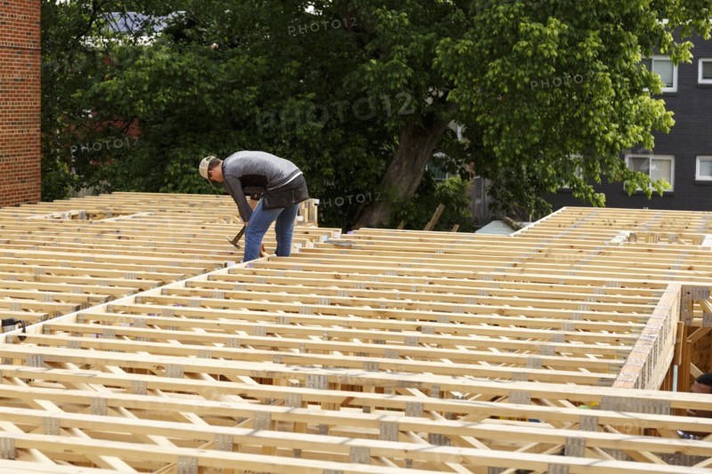 Distant Caucasian man hammering frame at construction site