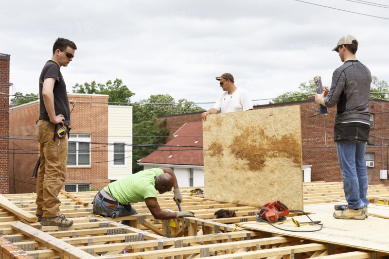 Volunteers working on the roof at construction site