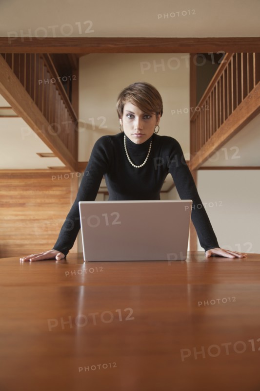 Caucasian woman using laptop on table