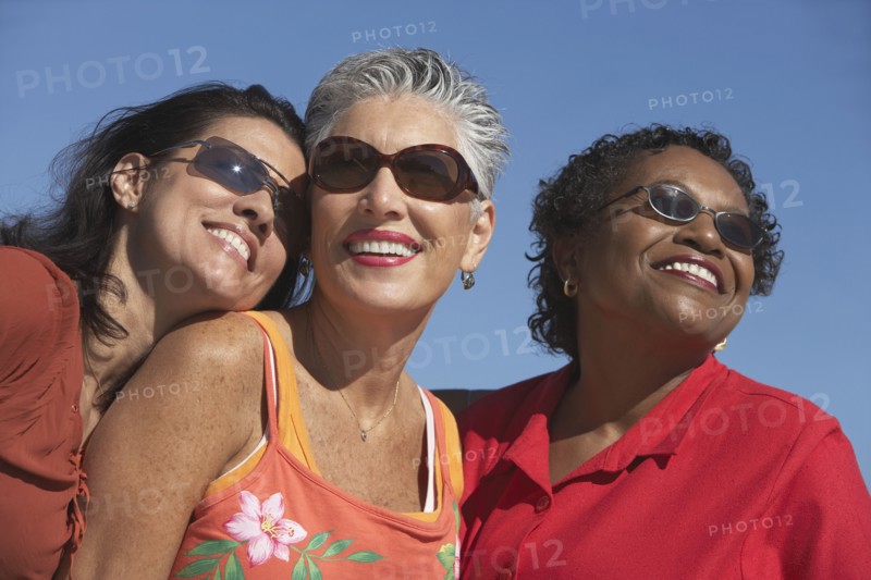 Three middle-aged women smiling