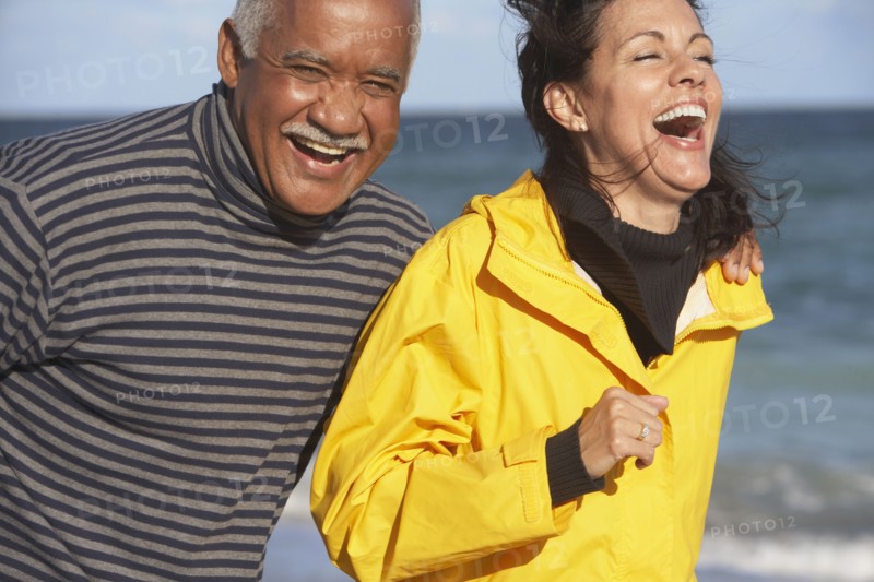 Senior couple laughing at beach