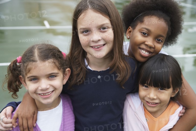 Multi-ethnic children hugging