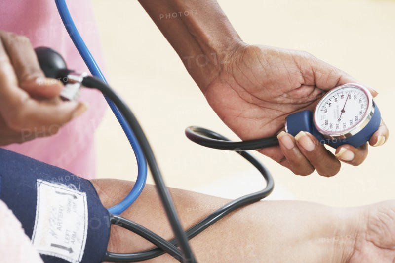 Nurse taking senior's blood pressure