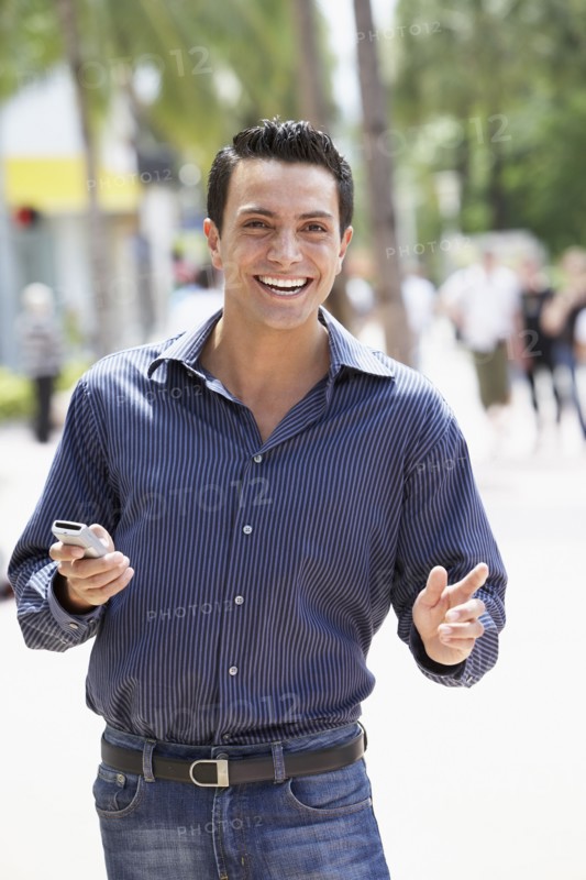 Spanish man holding cell phone