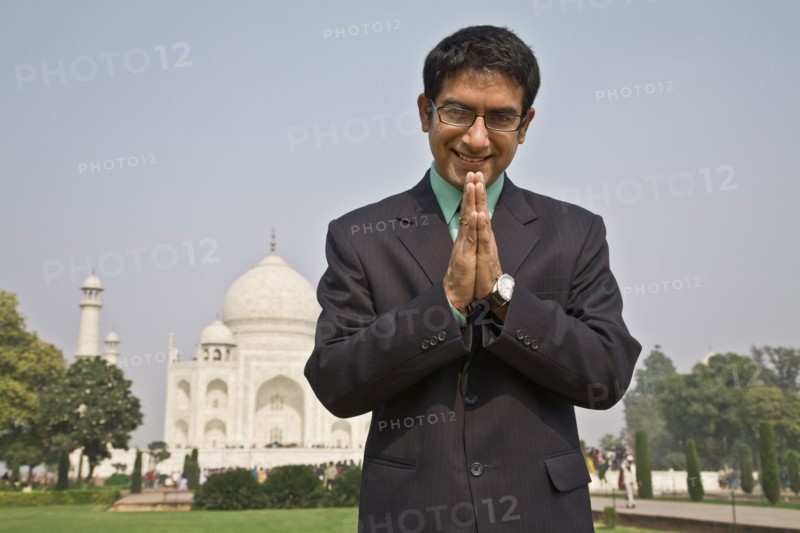 Indian businessman praying at the Taj Mahal