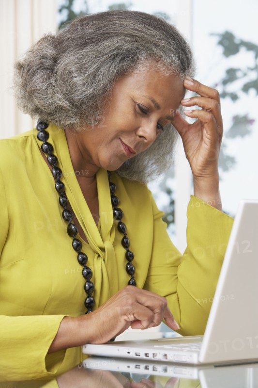 African woman using laptop at home